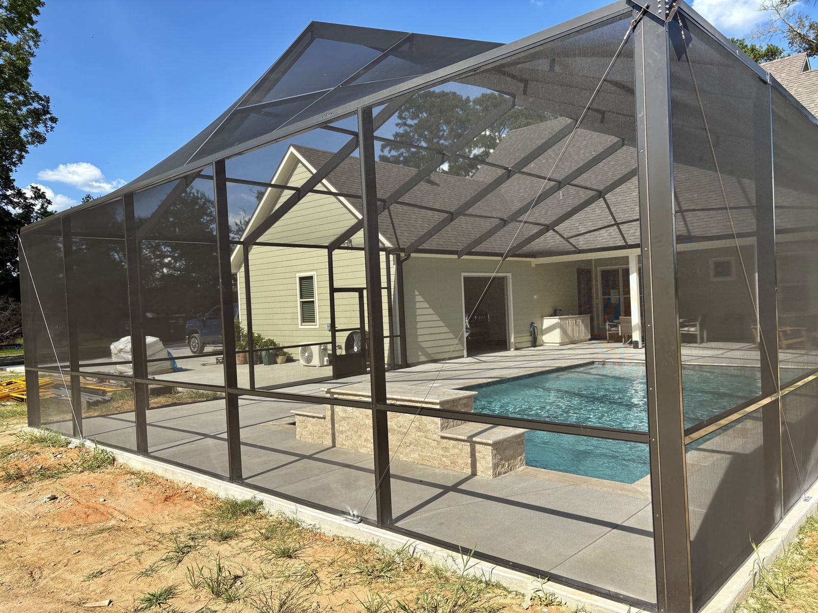 Black aluminum pool screen enclosure over an in-ground pool, Southwest Louisiana