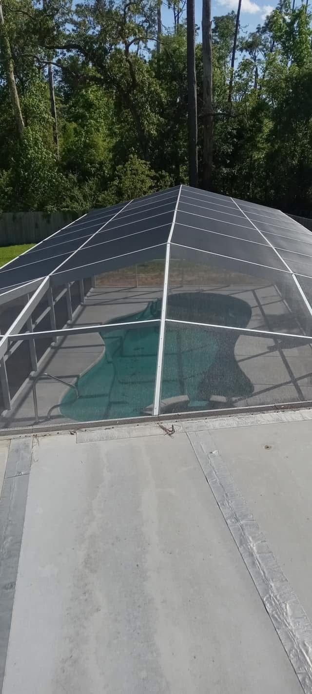Domed white pool enclosure roof over a pool seen from above