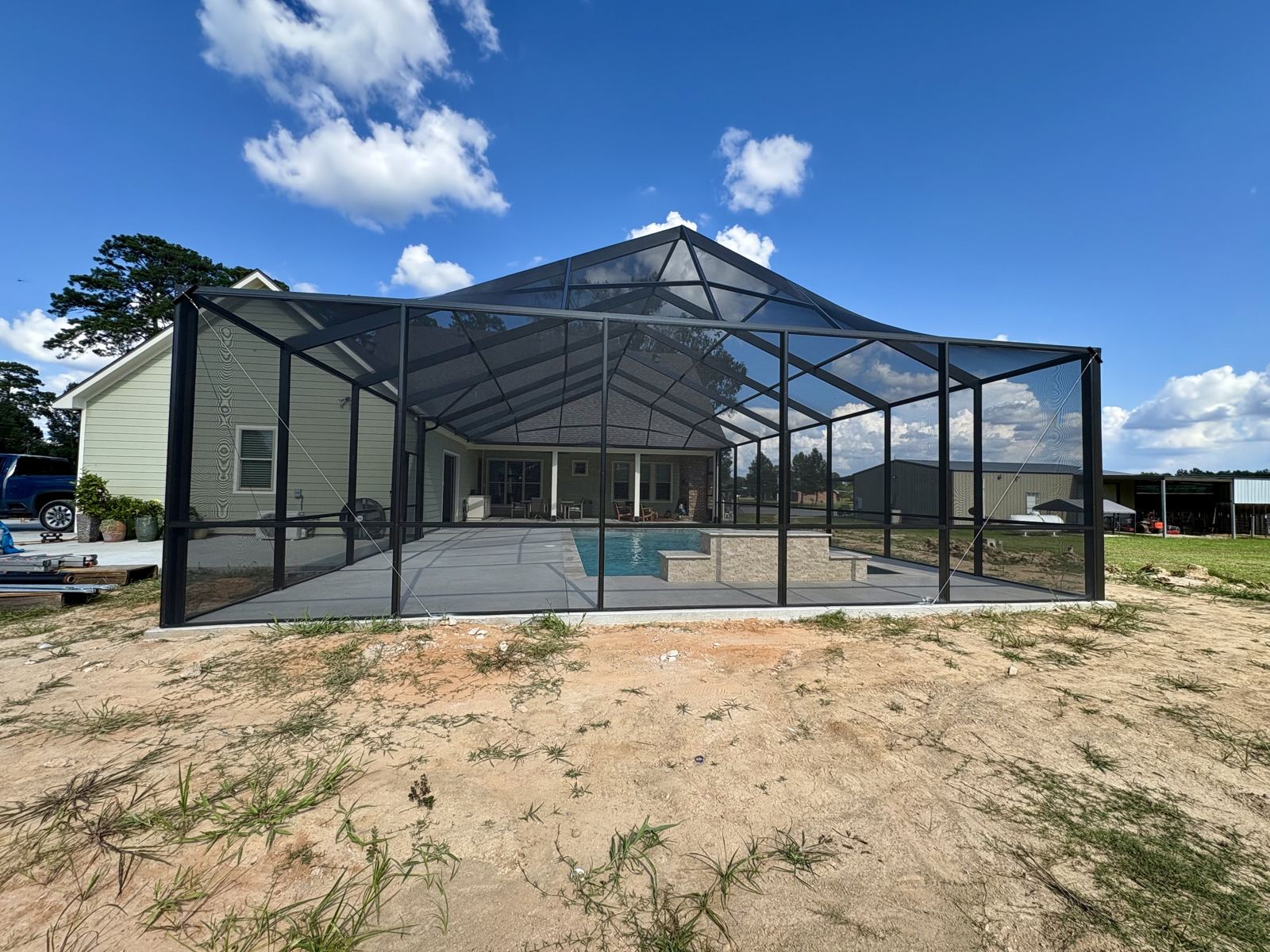 Full pool screen enclosure with tall roof frame, rear view