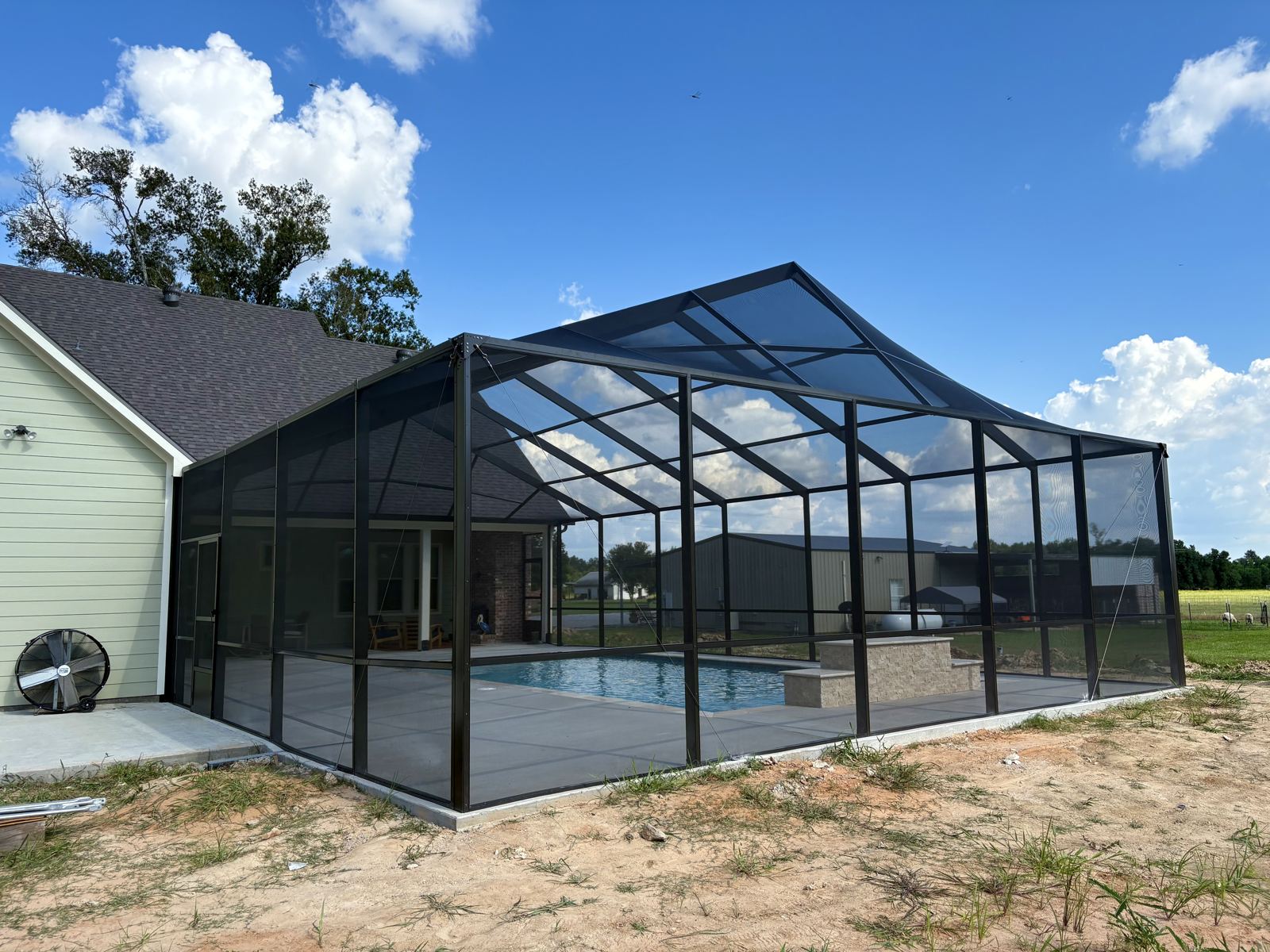 Pool screen enclosure seen from the back yard