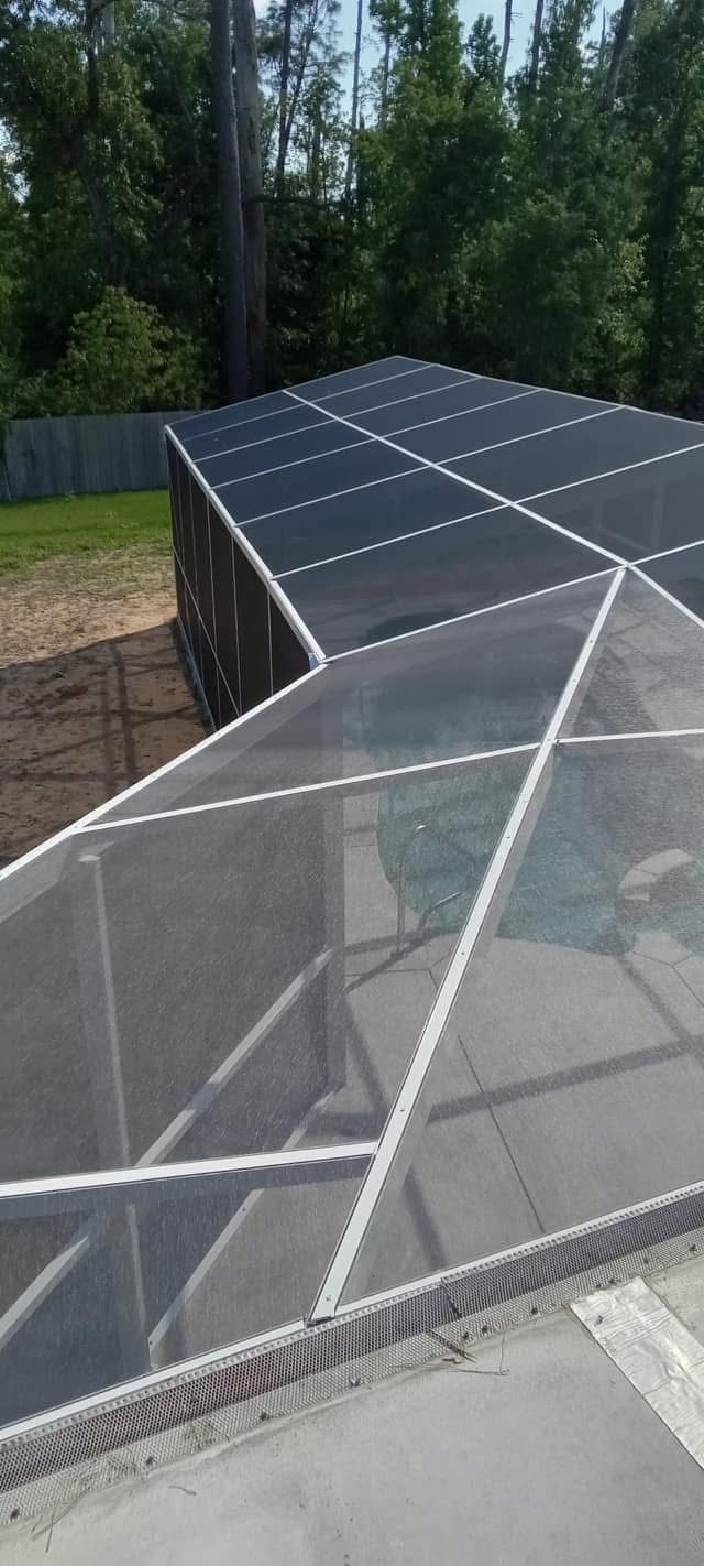 White-framed pool screen enclosure roof seen from above
