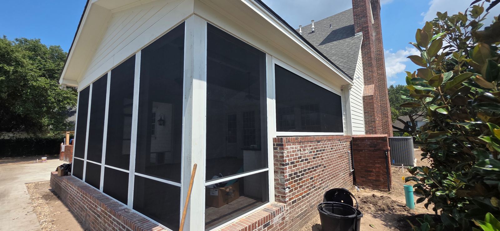 Gable porch enclosed with screen panels and chair rail