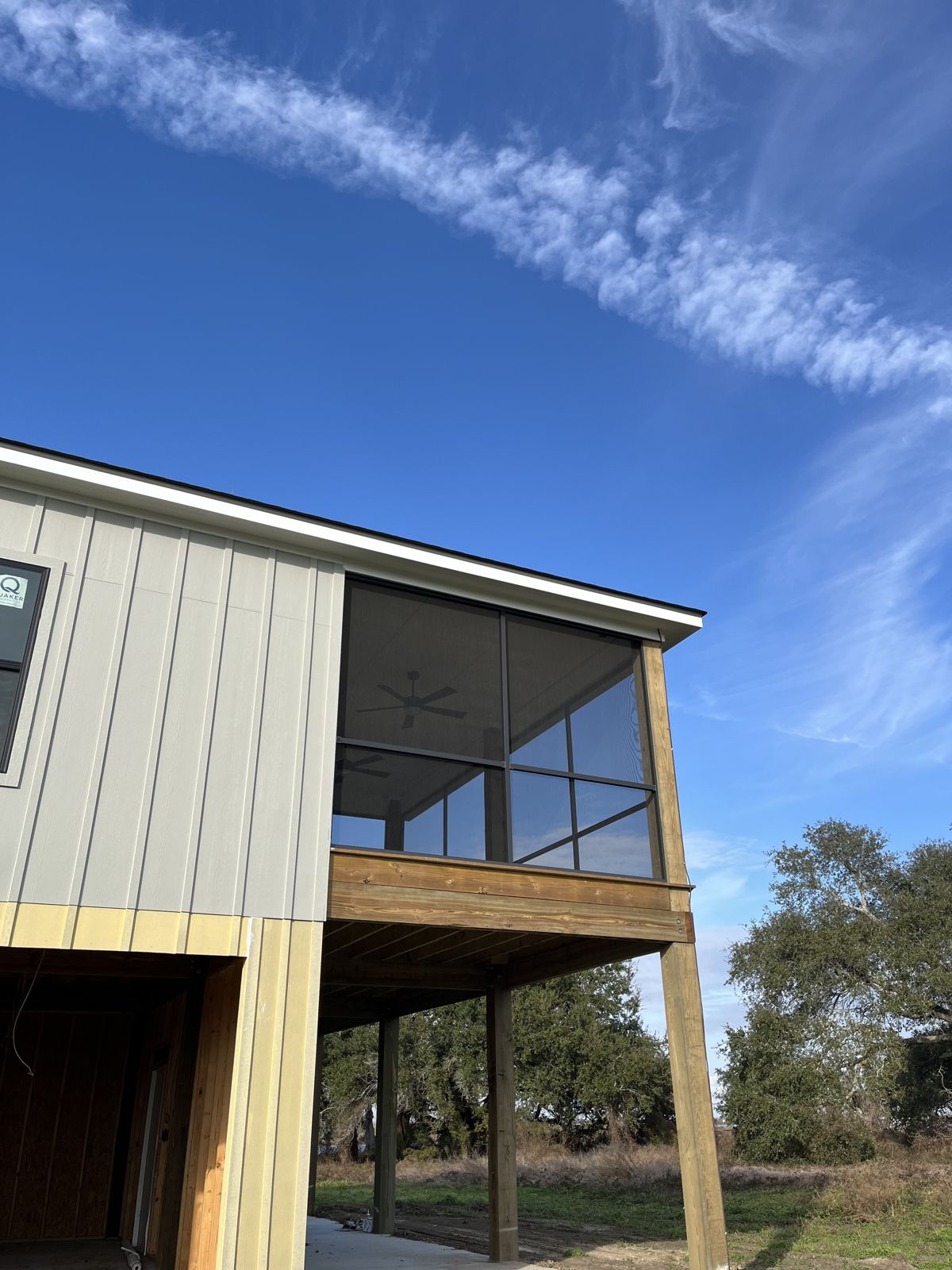 Screened upper porch on a raised home