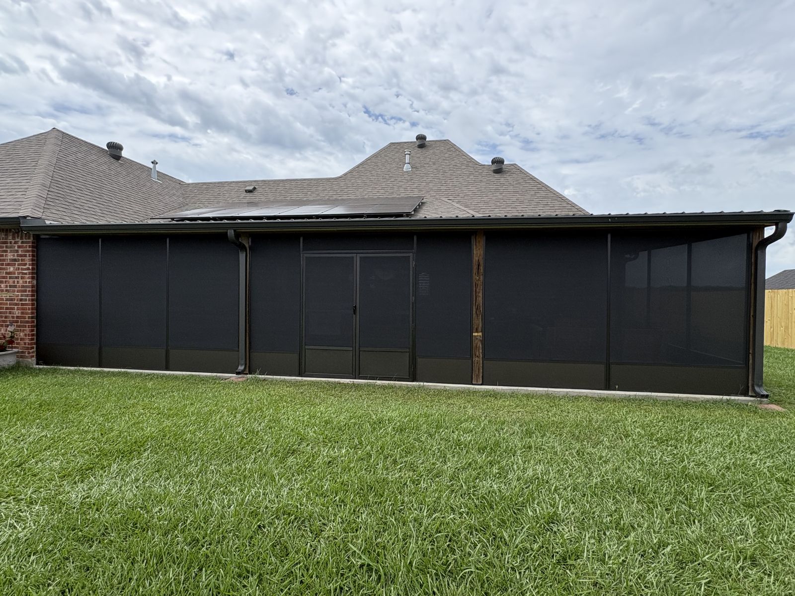 Long dark bronze screen room with double screen doors and kick panels