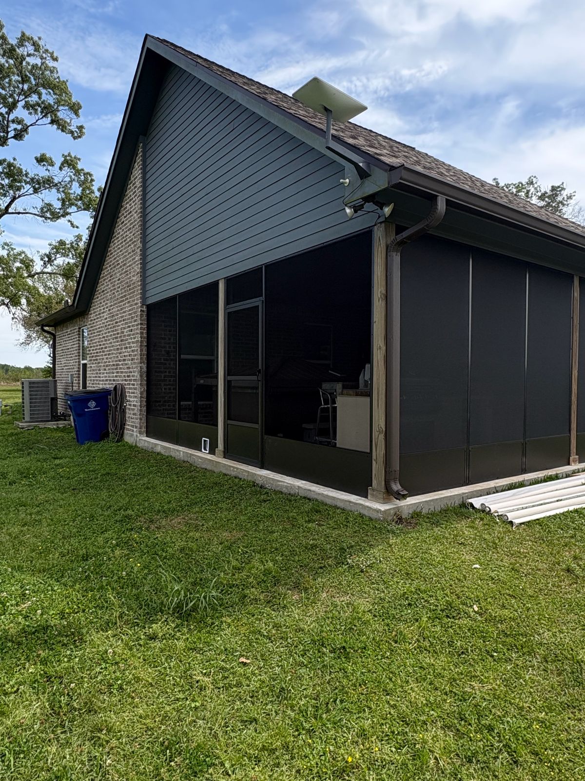 Dark bronze screen room on the side of a gabled home