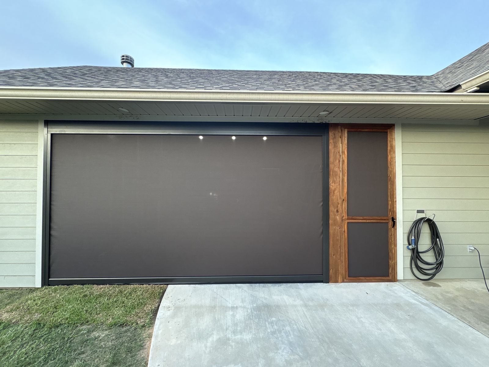 Brown shade lowered beside a wood-framed door