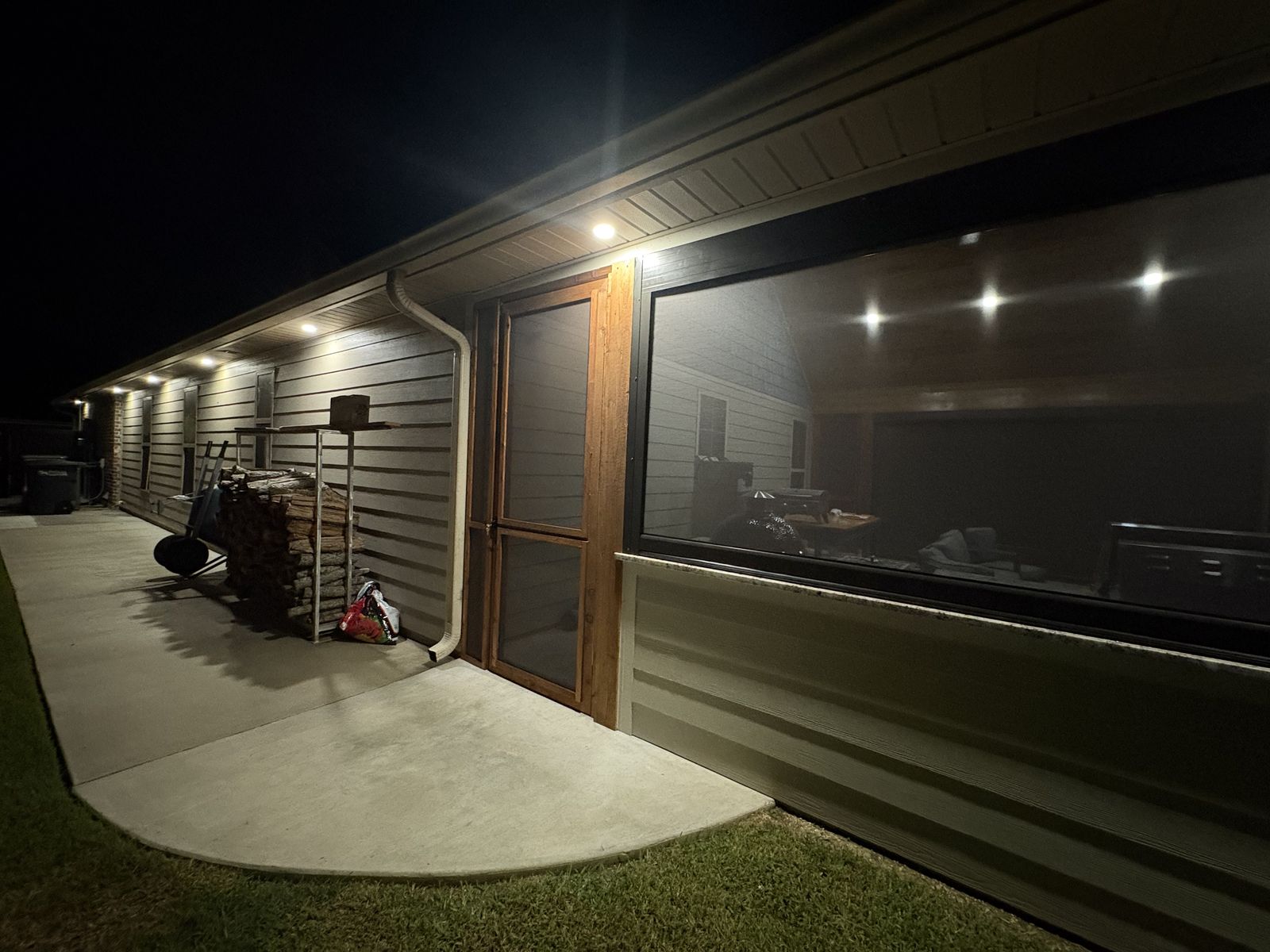 Porch at night with a lowered shade and wood door